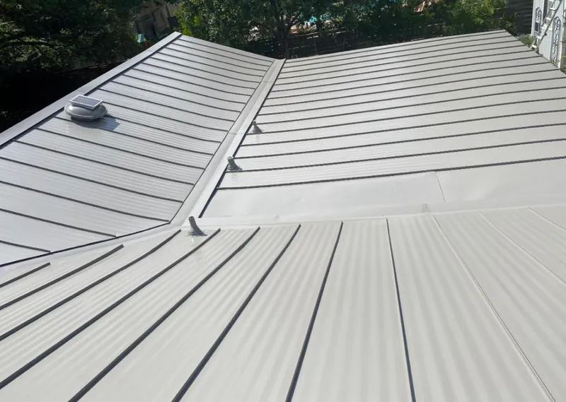 Solar attic fan installed on a metal roof for Roof Ventilation in Fort Lauderdale
