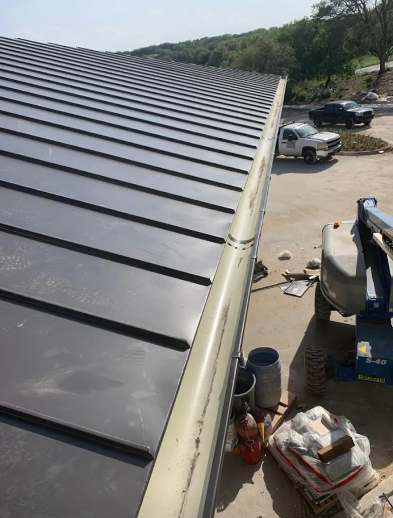 Standing seam panel and gutter detail on a metal roofing jobsite in Fort Lauderdale